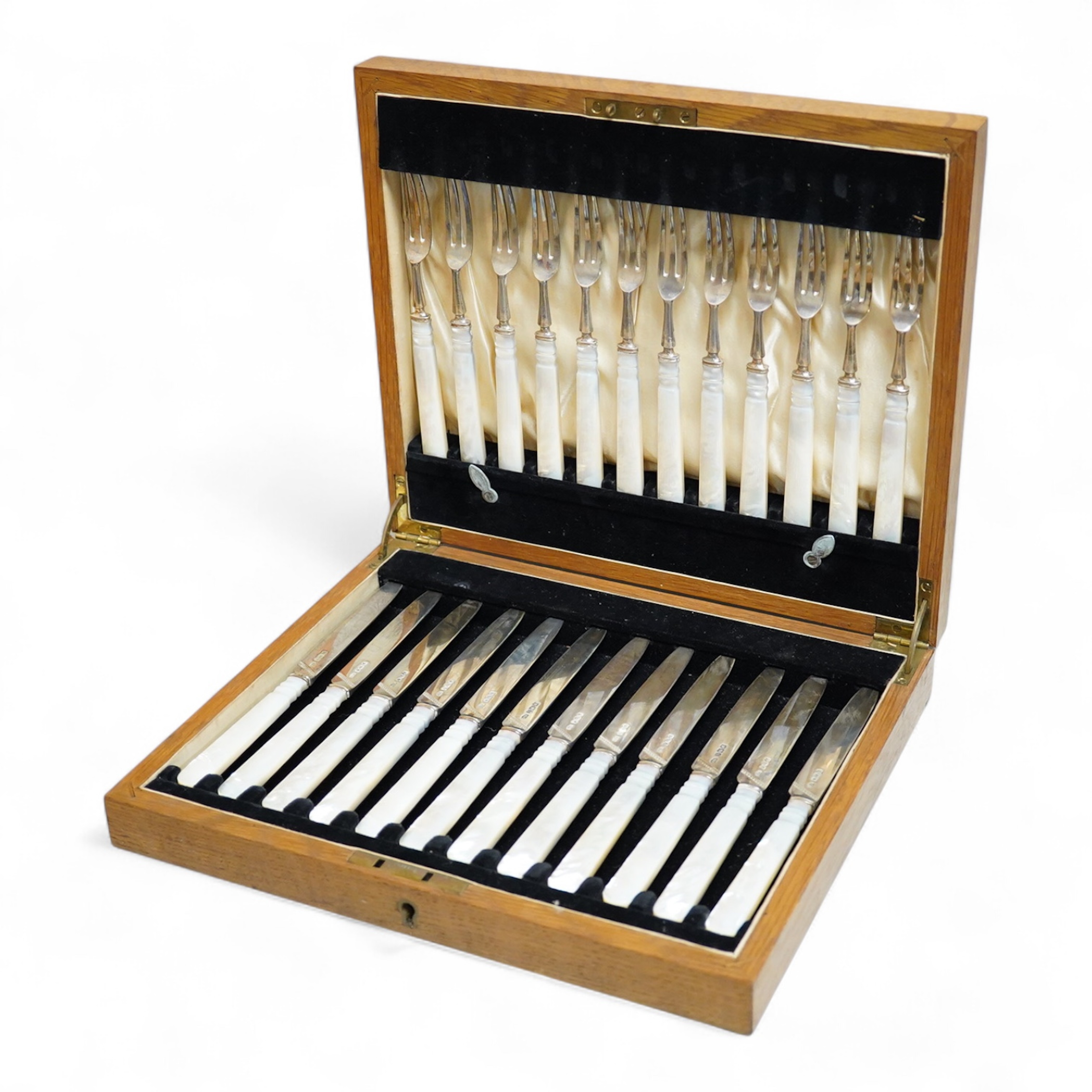 A set of twelve pairs of George V mother of pearl handled silver dessert eaters, by Roberts & Belk, Sheffield, 1926, knife 19.3cm, in a fitted oak box.